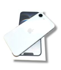 White iPhone with camera bump resting on its box, showcasing the back with Apple's logo clearly visible.