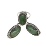 Silver jewelry set featuring three oval green stones with twisted rope borders: one ring and two matching drop earrings on a white background.