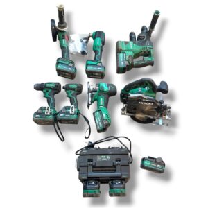 Collection of green Hikoki cordless power tools with charger and batteries laid out on white background.