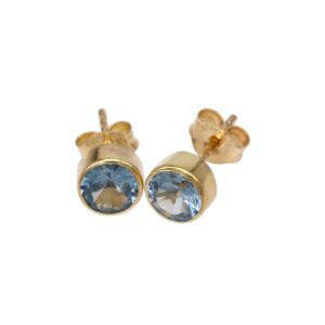 Gold stud earrings with light blue round-cut gems set in smooth bezels on a gold backing.